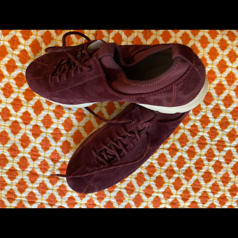 Burgundy suede sneakers.